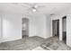 Bright bedroom features a closet, bathroom access, and a ceiling fan at 6410 W Winslow Ave, Phoenix, AZ 85043
