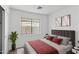 Bright bedroom boasts a neutral palette and ample natural light from a window at 6410 W Winslow Ave, Phoenix, AZ 85043