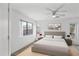 Bright bedroom features a neutral color palette, ceiling fan, and plush carpet at 6410 W Winslow Ave, Phoenix, AZ 85043