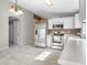 Open-concept kitchen features stainless steel appliances and white cabinets at 6410 W Winslow Ave, Phoenix, AZ 85043
