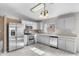 Well-lit kitchen features stainless steel appliances, tile floors and white cabinets at 6410 W Winslow Ave, Phoenix, AZ 85043