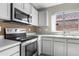 Close up of the kitchen featuring stainless steel oven, microwave, and sink at 6410 W Winslow Ave, Phoenix, AZ 85043