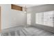 Spacious living room with a front door view and neutral carpet and wall colors at 6410 W Winslow Ave, Phoenix, AZ 85043