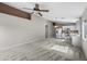 Open-concept living room and kitchen with carpeted floor and ceiling fan at 6410 W Winslow Ave, Phoenix, AZ 85043