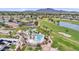 High-angle view of a community pool area with palm trees, and desert landscaping at 6811 S Four Peaks Way, Chandler, AZ 85249