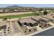 A high-angle view showing a home on the golf course with desert landscaping and mountains at 6811 S Four Peaks Way, Chandler, AZ 85249