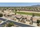 Aerial shot showcasing the well-planned community with golf course and mountain views at 6811 S Four Peaks Way, Chandler, AZ 85249