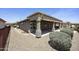 The backyard has low-maintenance desert landscaping, including gravel and bushes, and a covered patio at 6811 S Four Peaks Way, Chandler, AZ 85249