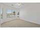 Bright, carpeted bedroom features a ceiling fan and windows with blinds allowing natural light in at 6811 S Four Peaks Way, Chandler, AZ 85249