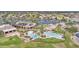 Community center featuring tennis courts, multiple pools, lush lawns, palm trees, and solar panel roofing at 6811 S Four Peaks Way, Chandler, AZ 85249