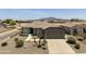 Well-maintained single-story home with desert landscaping, a two-car garage, and a charming, inviting exterior at 6811 S Four Peaks Way, Chandler, AZ 85249