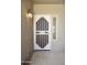 Stylish white front door with decorative security screen and sidelight for added security and natural light at 6811 S Four Peaks Way, Chandler, AZ 85249