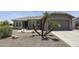 Expansive desert landscaping defines this home with a charming front patio and walkway leading to the front door at 6811 S Four Peaks Way, Chandler, AZ 85249