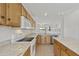 Traditional kitchen features wood cabinets, granite counters, and white appliances overlooking an open concept living space at 6811 S Four Peaks Way, Chandler, AZ 85249