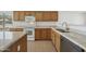 Bright kitchen has oak cabinets, granite countertops, an island, and modern stainless steel appliances at 6811 S Four Peaks Way, Chandler, AZ 85249