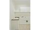 Bright laundry room has white cabinets and a utility sink, providing a functional space for all your laundry needs at 6811 S Four Peaks Way, Chandler, AZ 85249