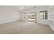 This large carpeted living room boasts sliding glass door access to the patio and neighborhood views at 6811 S Four Peaks Way, Chandler, AZ 85249