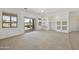 Spacious living room features neutral carpet, large windows, and a sliding door for plenty of light at 6811 S Four Peaks Way, Chandler, AZ 85249