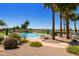 Sparkling pool featuring palm trees, beautiful landscaping, lounge chairs, and desert views at 6811 S Four Peaks Way, Chandler, AZ 85249