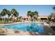 Beautiful pool with clear blue water, lounge chairs, desert landscaping, and a view of the clubhouse at 6811 S Four Peaks Way, Chandler, AZ 85249