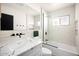 Bright bathroom featuring a subway tile shower, black hardware, and a marble countertop at 7508 N 13Th Ave, Phoenix, AZ 85021