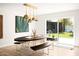 Modern dining area with unique lighting, stylish seating, and sliding glass doors to backyard at 7508 N 13Th Ave, Phoenix, AZ 85021