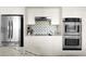 Elegant kitchen boasting stainless steel appliances, modern backsplash, and sleek countertops at 7508 N 13Th Ave, Phoenix, AZ 85021