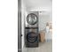 This laundry room features a modern stacked washer and dryer with stylish decor at 7508 N 13Th Ave, Phoenix, AZ 85021