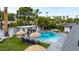Backyard pool with lounge chairs, outdoor kitchen, and manicured lawn at 7508 N 13Th Ave, Phoenix, AZ 85021