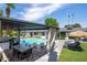 Backyard showcasing the pool, outdoor kitchen, covered dining area, and stylish lounge seating at 7508 N 13Th Ave, Phoenix, AZ 85021