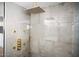 Luxury shower showcasing gold fixtures, sleek concrete-like tile, and modern design details in a glass-enclosed space at 7508 N 13Th Ave, Phoenix, AZ 85021