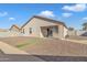 The backyard has gravel and a strip of artificial turf along the back of the house at 7580 W Darrel Rd, Laveen, AZ 85339
