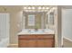 Bathroom boasts a double sink vanity with wood cabinets and a large mirror reflecting ample natural light at 7580 W Darrel Rd, Laveen, AZ 85339