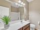 Bathroom boasts a vanity with a sink, toilet, and shower/tub featuring modern fixtures and clean lines at 7580 W Darrel Rd, Laveen, AZ 85339