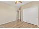 Bedroom featuring wood floors, ceiling fan, and a closet, providing functionality and style at 7580 W Darrel Rd, Laveen, AZ 85339