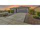 Well-kept single-story home featuring a large driveway and desert landscaping at 7580 W Darrel Rd, Laveen, AZ 85339