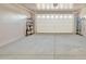 A clean garage space with an automatic door opener and ample room for storage at 7580 W Darrel Rd, Laveen, AZ 85339