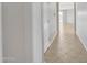 Clean hallway with tiled floors leading to a bright living area at 7580 W Darrel Rd, Laveen, AZ 85339