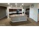 Kitchen featuring dark cabinets and granite countertops with a large center island at 7580 W Darrel Rd, Laveen, AZ 85339