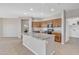 Open kitchen featuring a central island, granite countertops, and modern appliances at 7580 W Darrel Rd, Laveen, AZ 85339