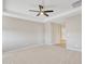 Main bedroom with neutral paint, carpet, a tray ceiling and ceiling fan at 7580 W Darrel Rd, Laveen, AZ 85339