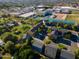 An aerial view featuring residential homes with tennis courts and buildings in the background at 827 E Pecan Rd, Phoenix, AZ 85040