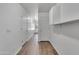 Well-lit hallway with wood floors and white walls at 827 E Pecan Rd, Phoenix, AZ 85040