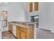 Bright kitchen featuring wood cabinets, white appliances, and views into the living room at 827 E Pecan Rd, Phoenix, AZ 85040