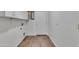 Laundry room featuring new washer/dryer hook-ups, storage cabinets and wood-look floors at 827 E Pecan Rd, Phoenix, AZ 85040