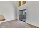 Bright living area with carpeted floors and sliding door access to outdoor patio at 827 E Pecan Rd, Phoenix, AZ 85040