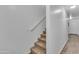 Carpeted stairs leading to an upper level, featuring white walls and a light-colored wood-look floor at 827 E Pecan Rd, Phoenix, AZ 85040