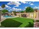 Spacious backyard featuring a pool, lush artificial turf, and tasteful decor at 9004 S Ash Ave, Tempe, AZ 85284