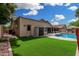 Spacious backyard with artificial turf, a refreshing pool, and comfortable outdoor seating at 9004 S Ash Ave, Tempe, AZ 85284