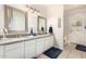 Bathroom with double sinks, white cabinets, granite counters and great lighting at 9004 S Ash Ave, Tempe, AZ 85284